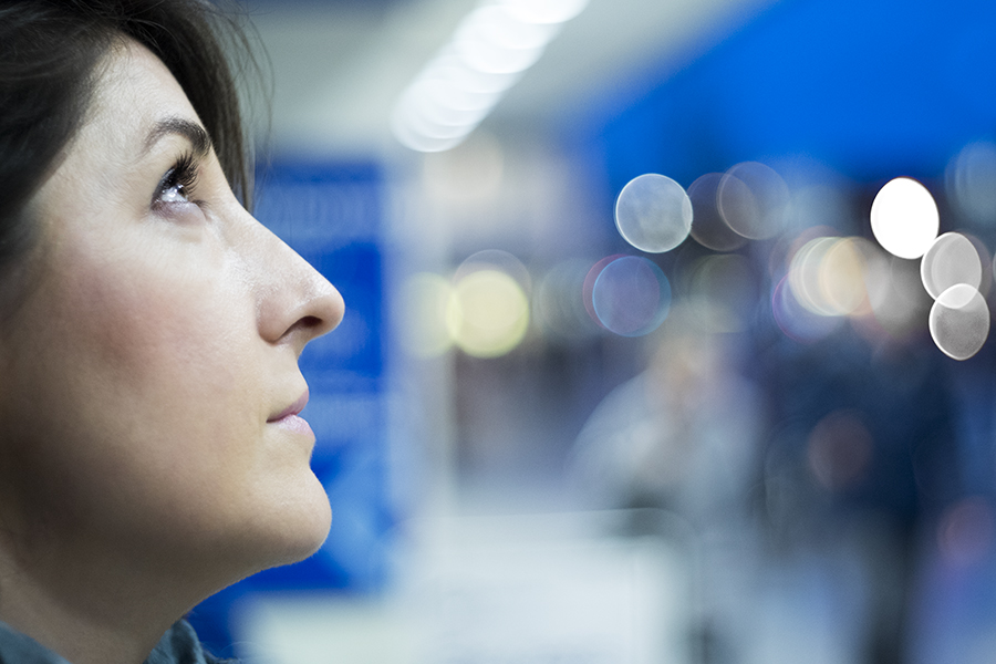 Photography Mentorship Student Woman looking up into dark sky with out of focus circles of light behind her to communicate hope for her dreams